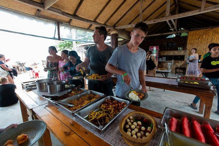 A food stall with various dishes and a crowd of people. 4
