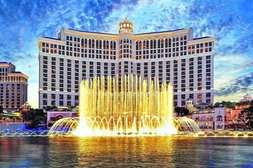 A large hotel with a fountain in front. 4