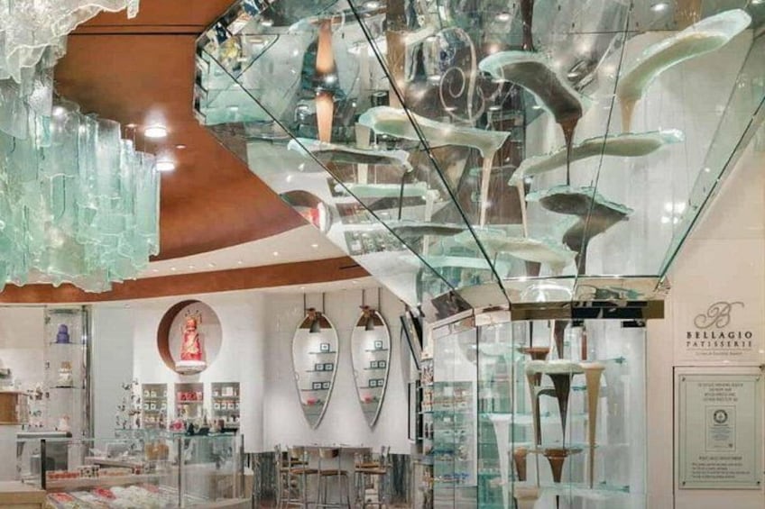 A glass ceiling with reflective surfaces and a store interior with glassware on display. 3