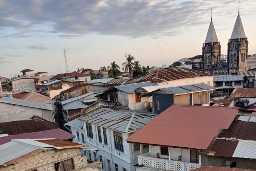 A densely packed urban area with various buildings, including a prominent church with two spires. 4