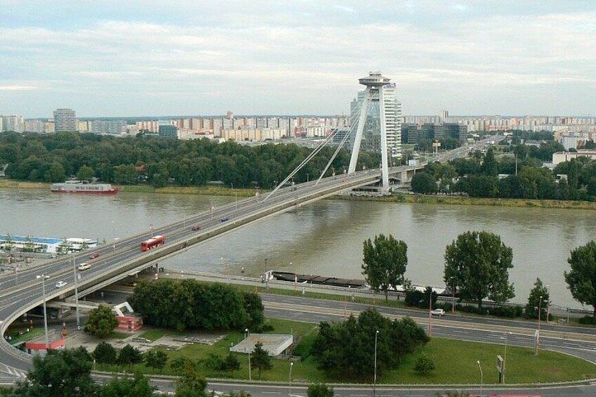 A bridge over a river with a cityscape in the background. 3