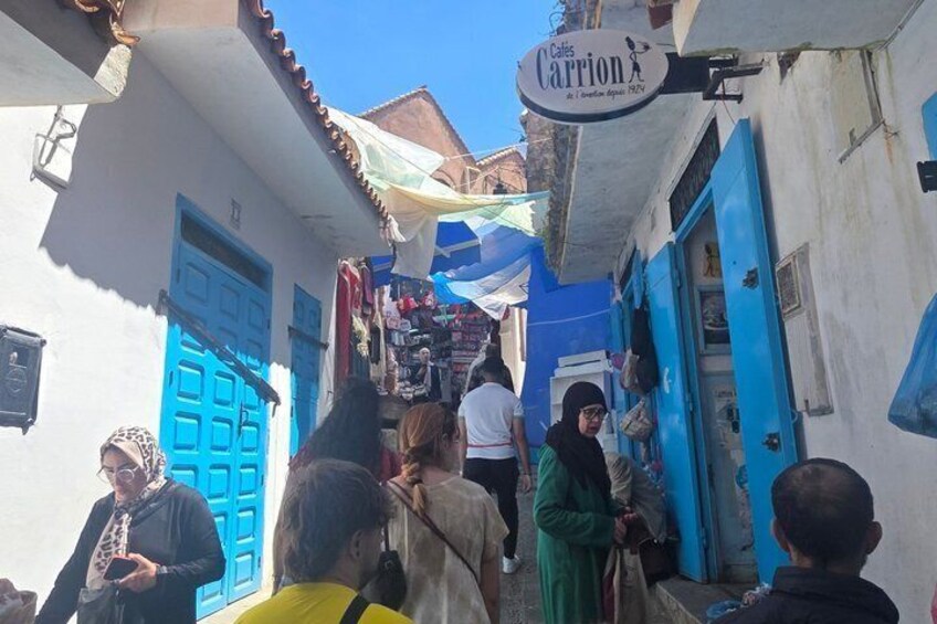 A narrow street with blue doors and a shop named 'Calle Carrion.' 3
