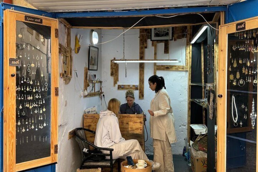 A jewelry shop with wooden walls and a display of necklaces. 5