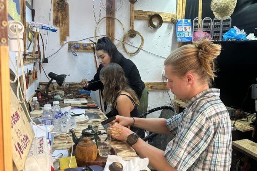A workshop with tools and materials, including a kettle and a table with various items. 2