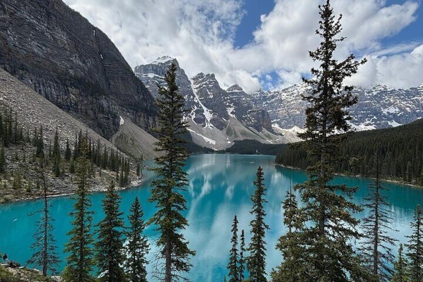 A turquoise lake surrounded by mountains and coniferous trees. 2