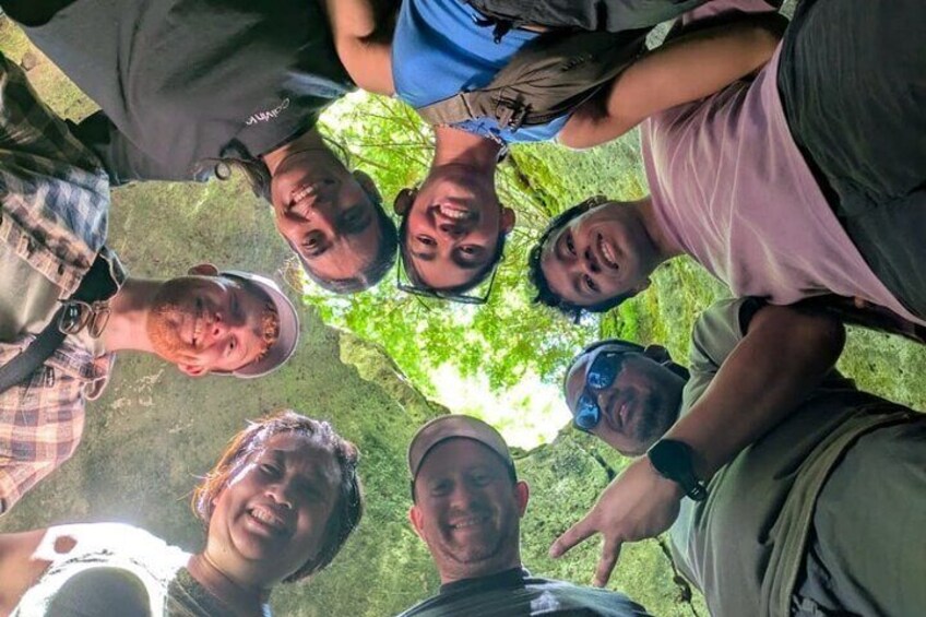 A group of people standing in a circle outdoors. 3