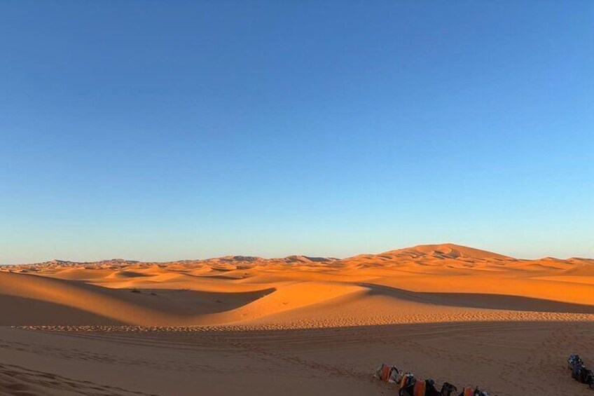 A desert landscape with sand dunes and a clear sky. 1