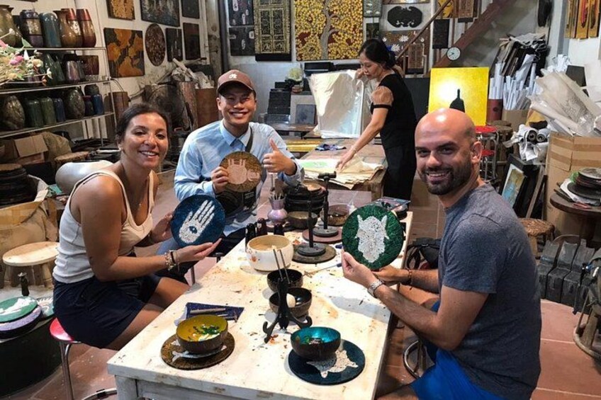 A pottery workshop with people working on ceramic pieces. 2