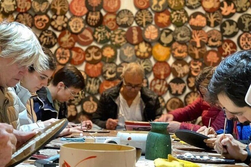 A group of people engaged in a craft activity, surrounded by various tools and materials. 5