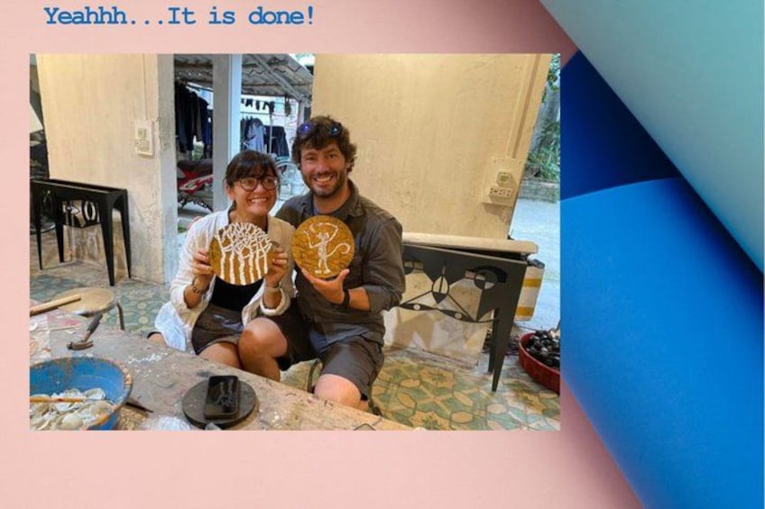 Two people holding circular objects, a table with food, and a chair. 2