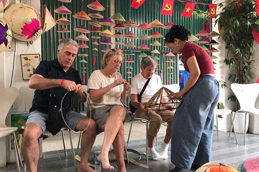 People engaged in a craft activity, surrounded by colorful paper umbrellas and flags. 2