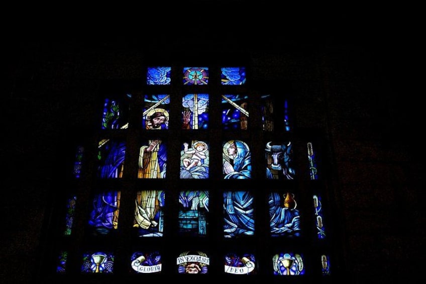 A stained glass window with religious figures and symbols. 5