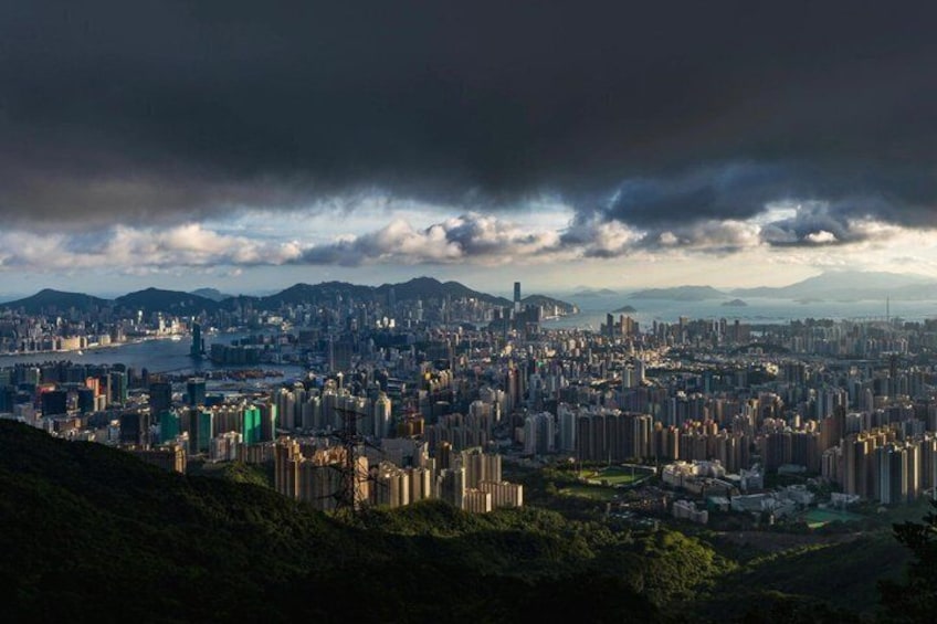 A cityscape with high-rise buildings, a river, and mountains in the background. 5