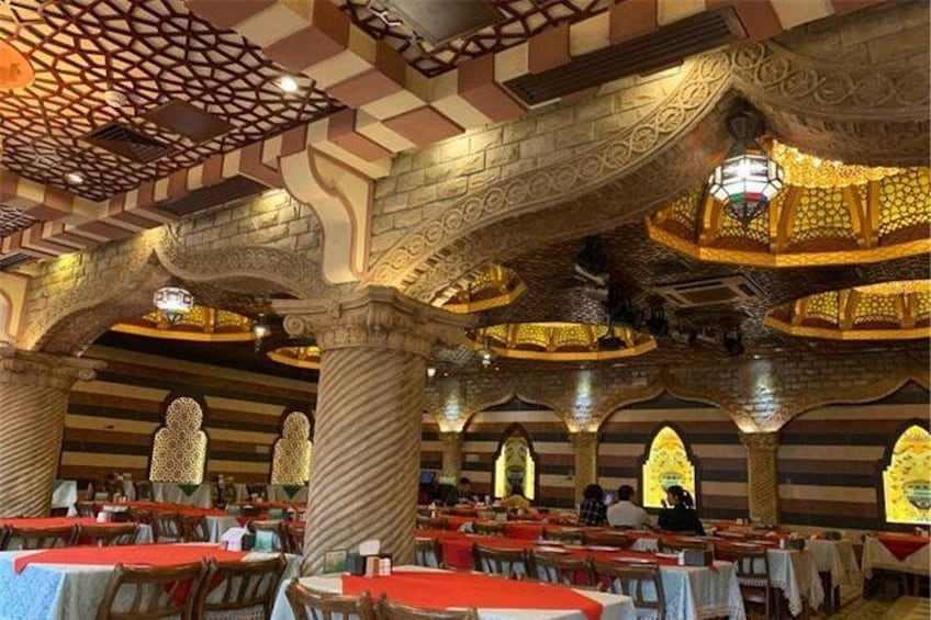 A restaurant with ornate arches, columns, and intricate ceiling designs. 3