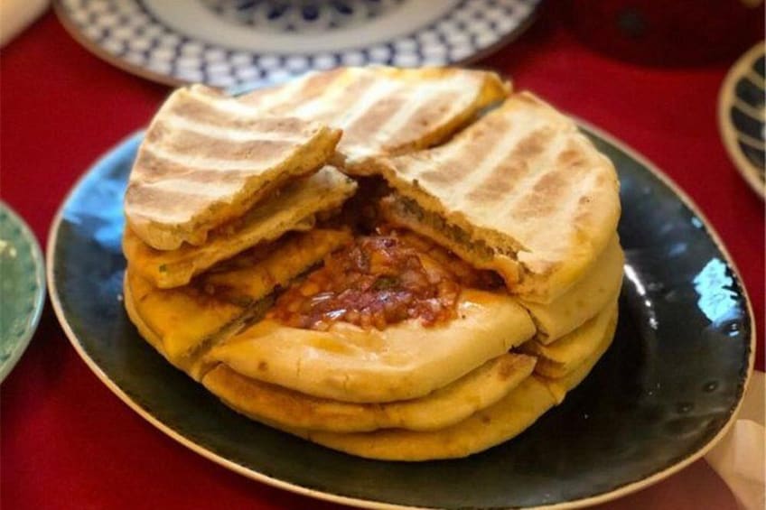 A stack of stuffed bread on a plate. 5
