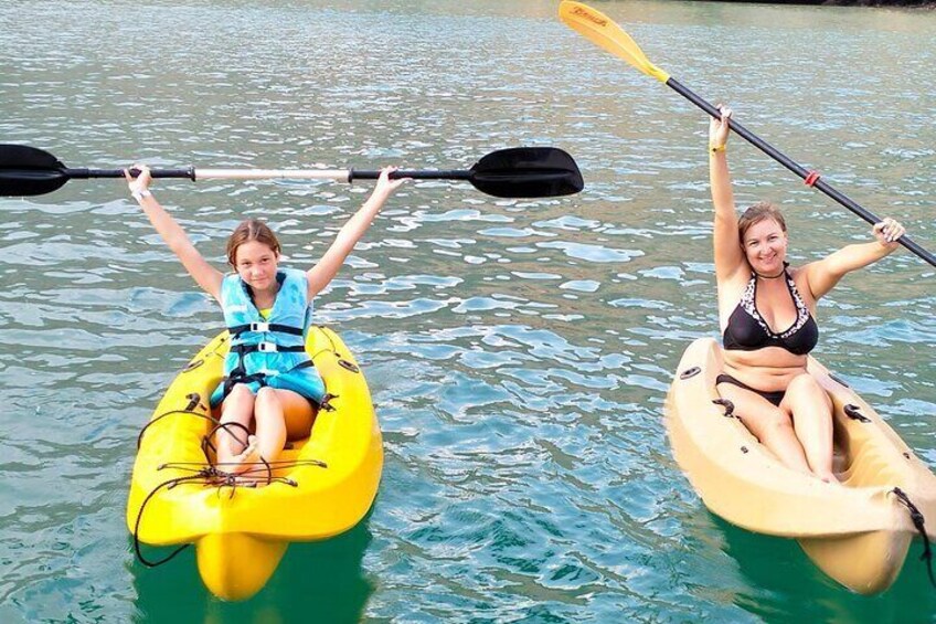 Two people kayaking on a calm river. 5