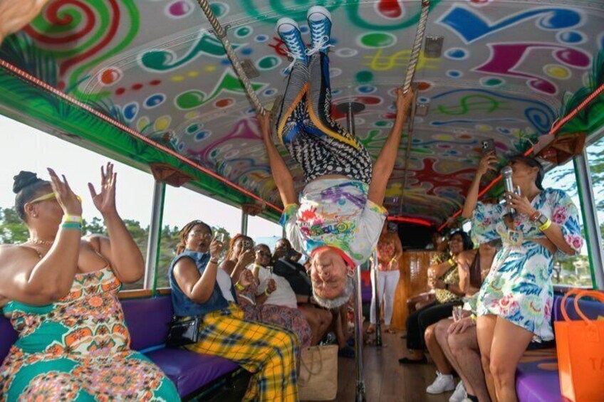 En businteriør med farverige mønstre på loftet og passagerer siddende. 3