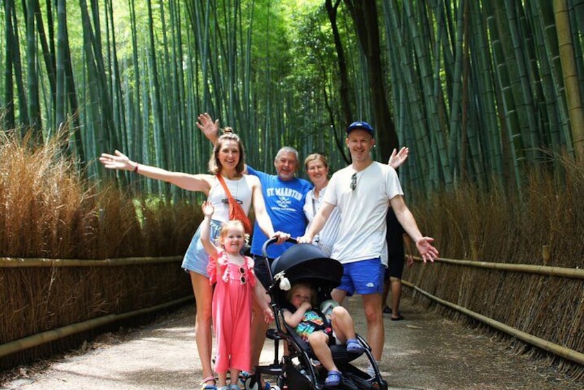 A group of people on a bamboo forest path. 5
