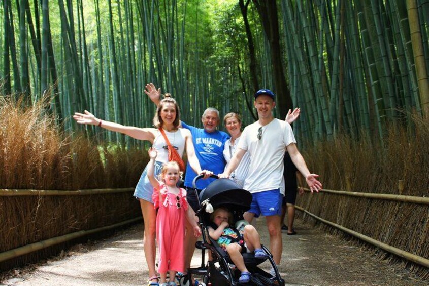 A group of people on a bamboo forest path. 2