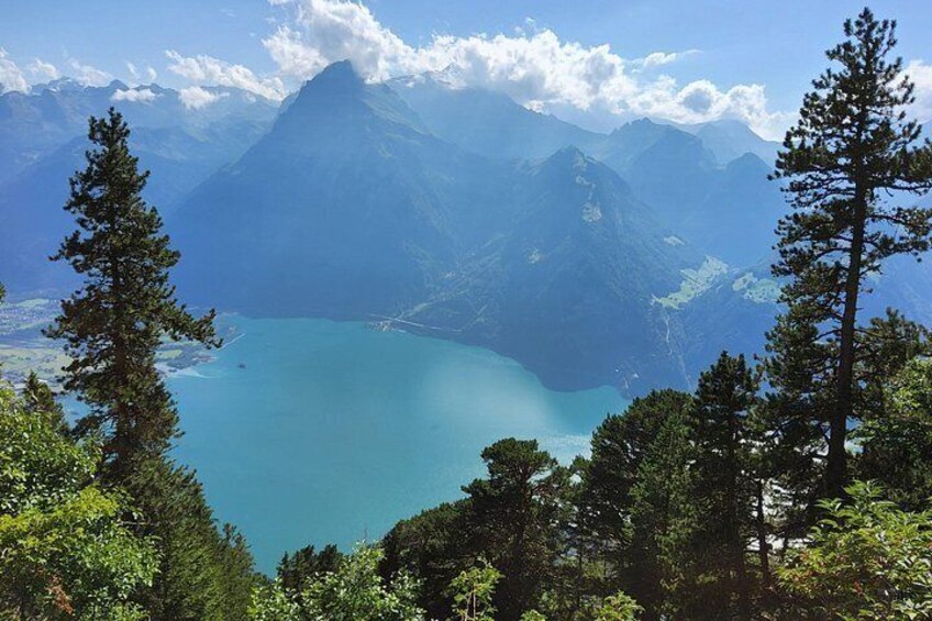 A mountain landscape with a lake and dense forest. 4