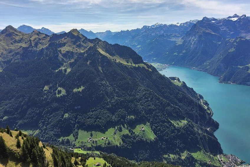 A mountainous landscape with a lake and a road. 2