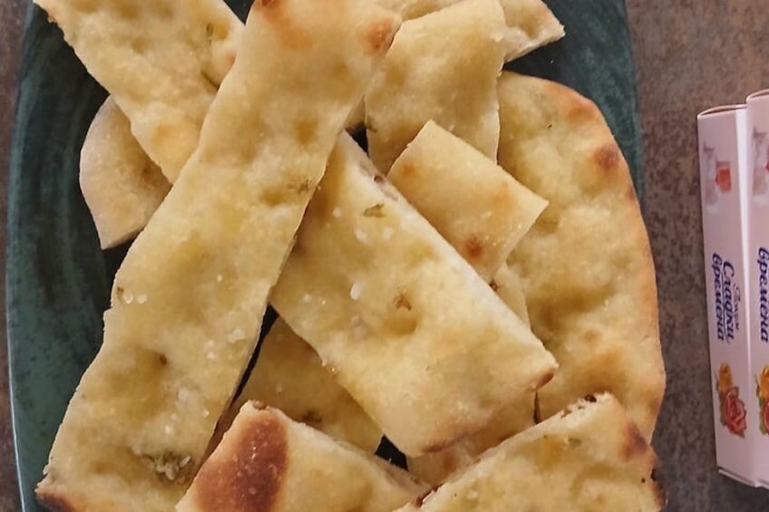 A plate of flatbread with a green background. 5