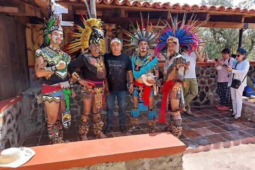 A group of people in traditional indigenous attire posing for a photo. 3