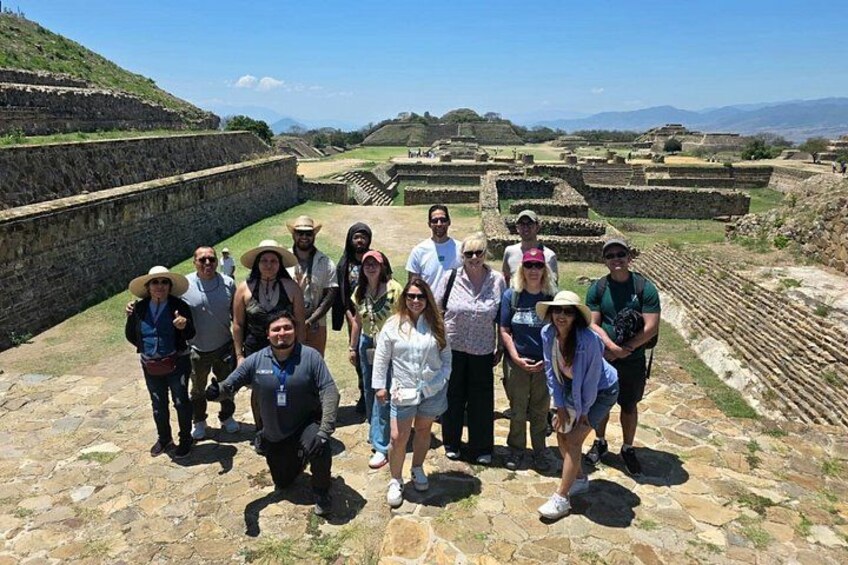 A group of people standing on ancient ruins with stone walls and stepped structures. 3
