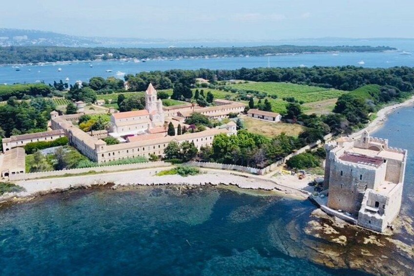 A coastal fortress with a tower, surrounded by water and greenery. 4