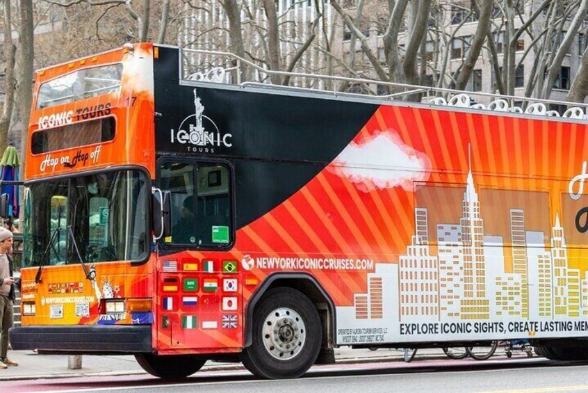 A double-decker bus with "Iconic Tours" branding and a cityscape design. 5