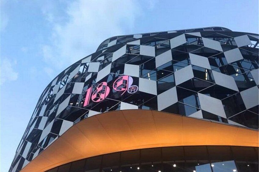 A modern building with a geometric facade and a prominent logo. 3