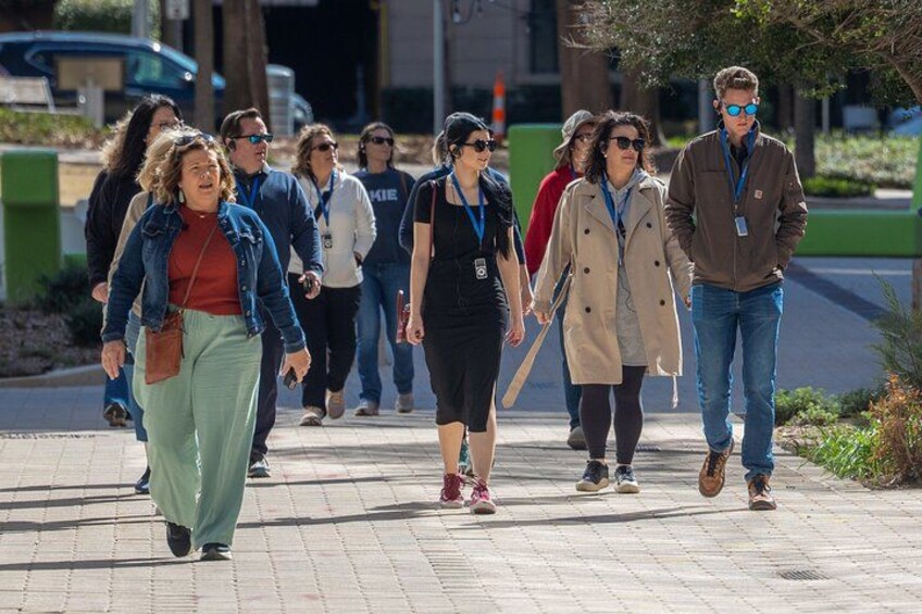 People walking on a paved path in an urban area. 3