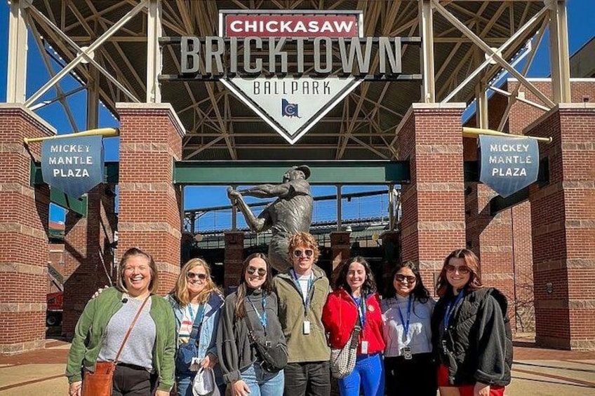 A group of people standing in front of the Chickasaw Bricktown Ballpark entrance. 3
