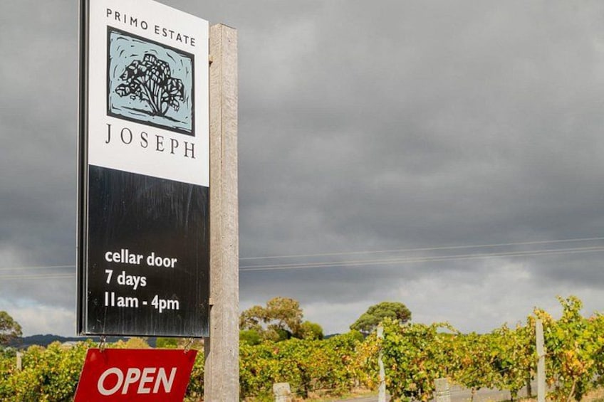 A property sign for Primo Estate Joseph, indicating a cellar door open 7 days a week from 11am to 4pm. 3
