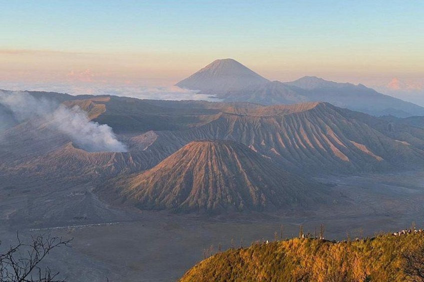 A volcanic landscape with distinct ridges and a mountain in the background. 2