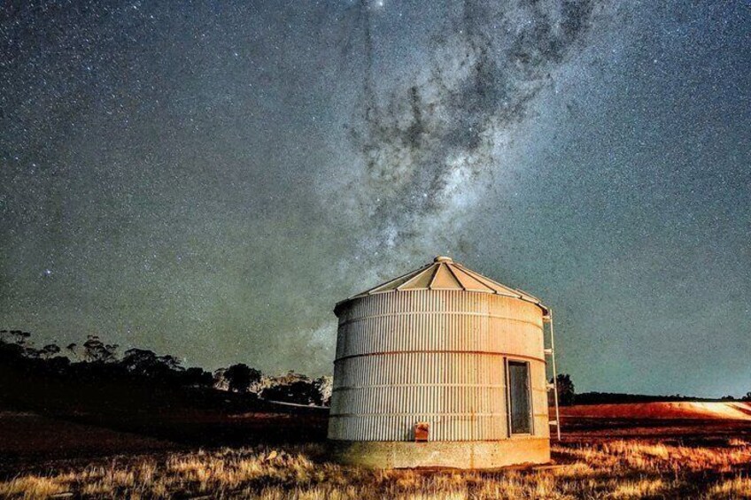 A silo under a starry sky with the Milky Way visible. 3