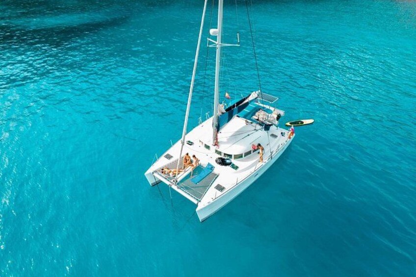 A white sailboat on turquoise water. 1