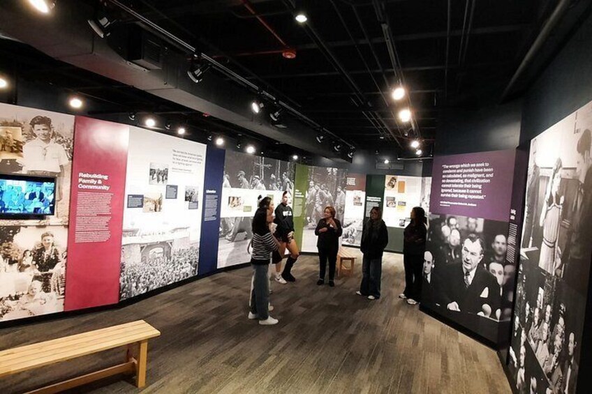 An indoor exhibition with informational panels and photographs. 5