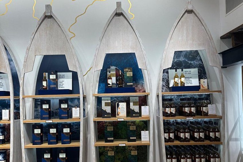 A wine cellar with shelves of bottles and informational plaques. 4
