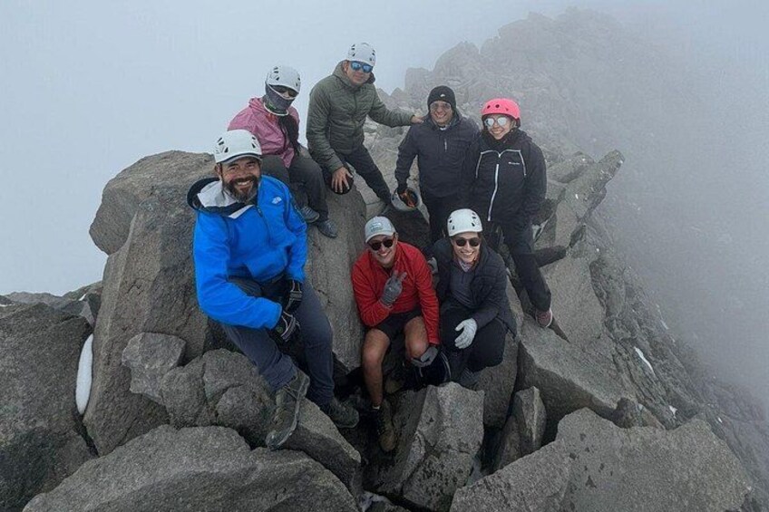 A group of people on a rocky mountain peak. 5