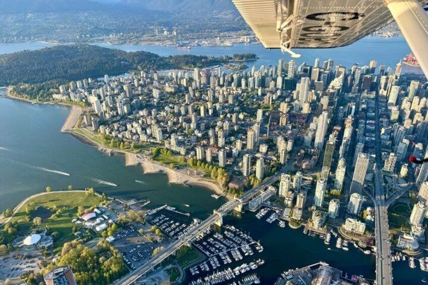 A cityscape with high-rise buildings, a waterfront, and a bridge. 3