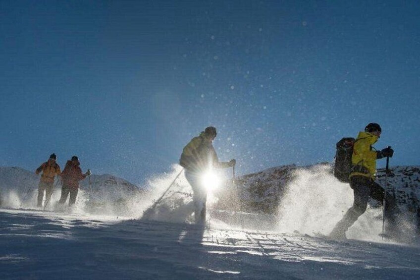 A group of people skiing on a snowy mountain. 2