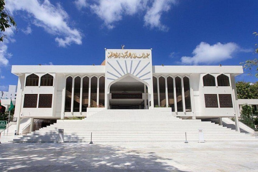 A white building with arched windows and a central entrance. 4