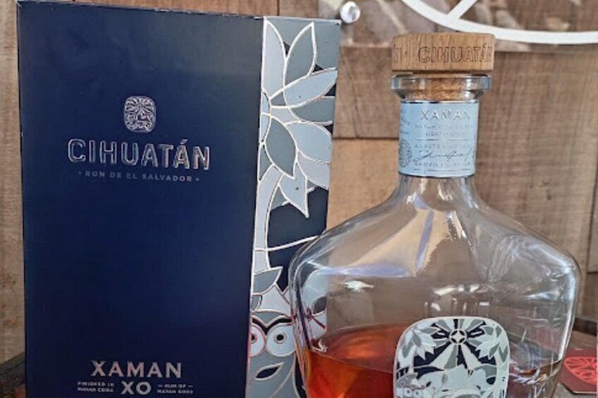 A bottle of Cihuatán XO tequila with a decorative label, placed next to its box. 5