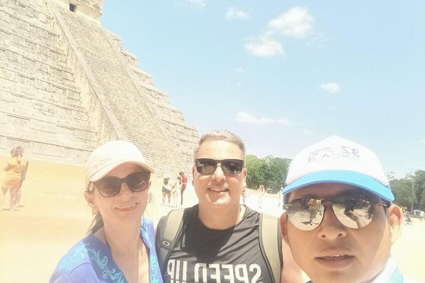 A pyramid structure, a person wearing a cap, and a person with a backpack. 4
