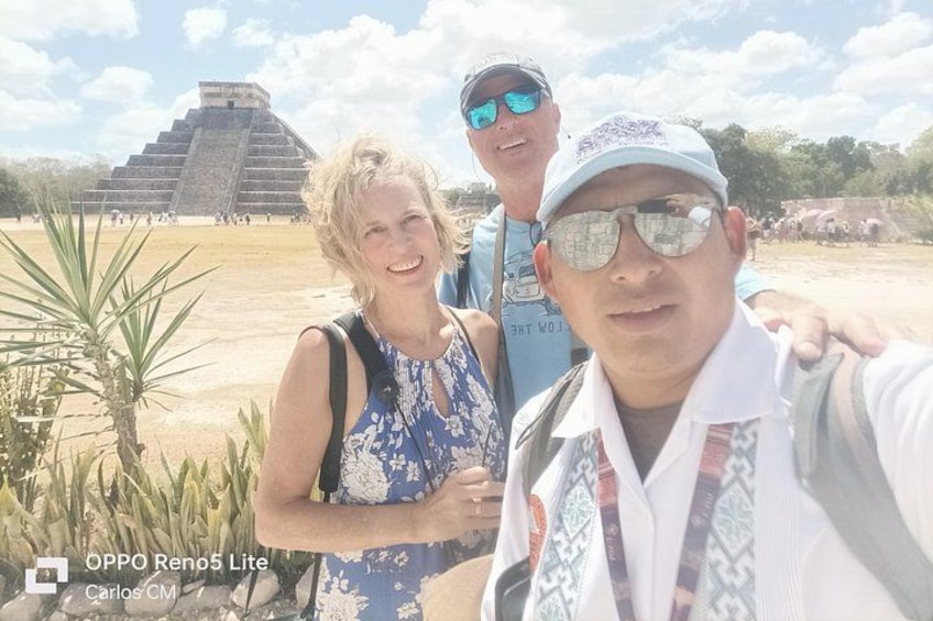 A pyramid, a person in a patterned shirt, and a person in a cap. 2