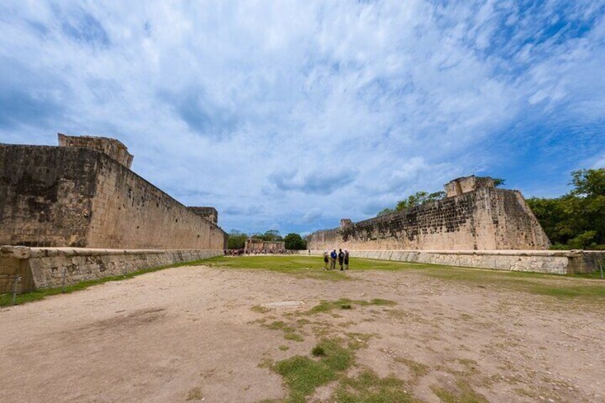 A historical fortification with walls and a grassy area. 5