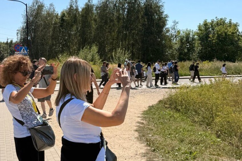 A group of people walking on a path surrounded by greenery. 2
