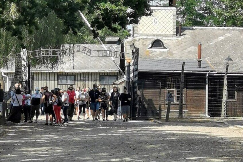 A group of people standing in front of a building with a sign that reads "Theater Museum." 3