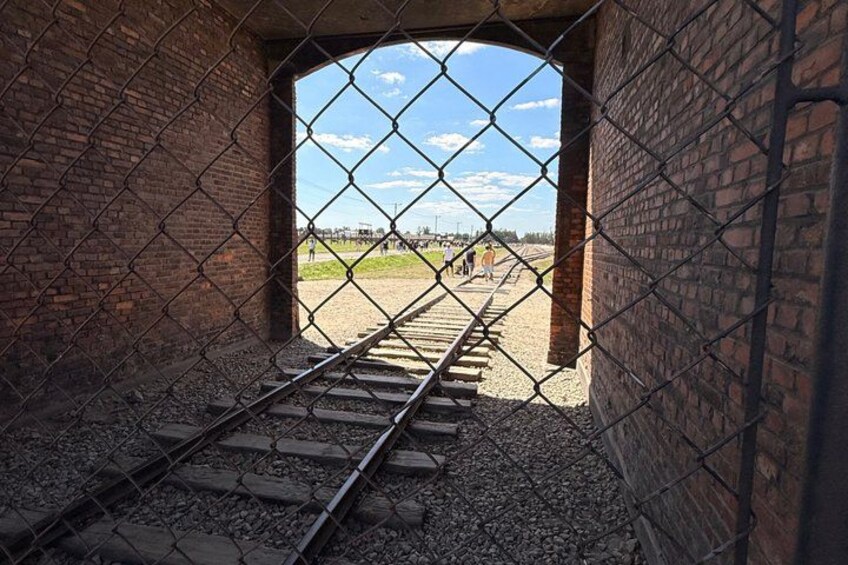A railway track through a brick archway. 5